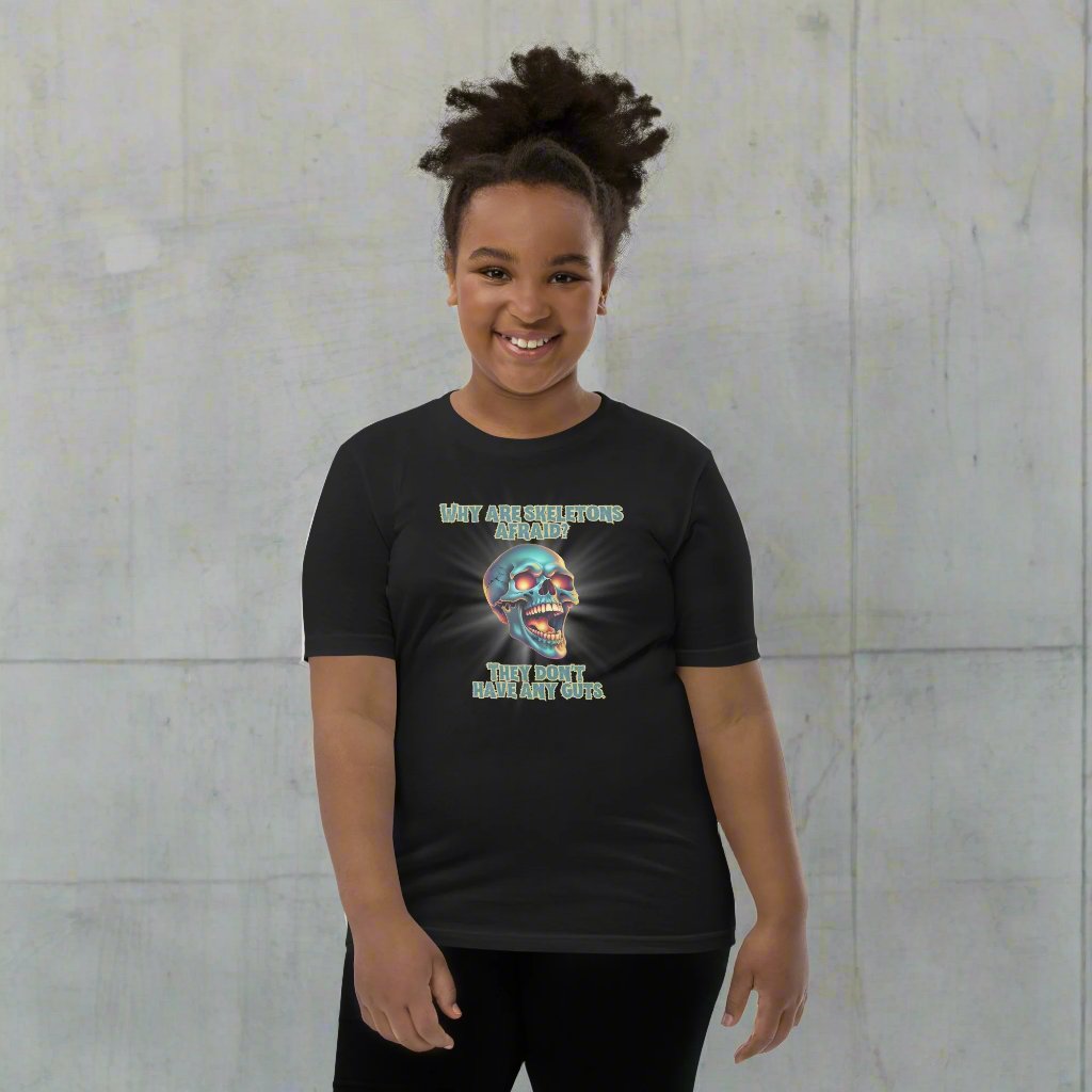 Halloween Skull Joke Shirt for Kids. This black tee features a laughing skull with the text "Why are skeletons afraid? They don't have any guts", by jaecrece.com