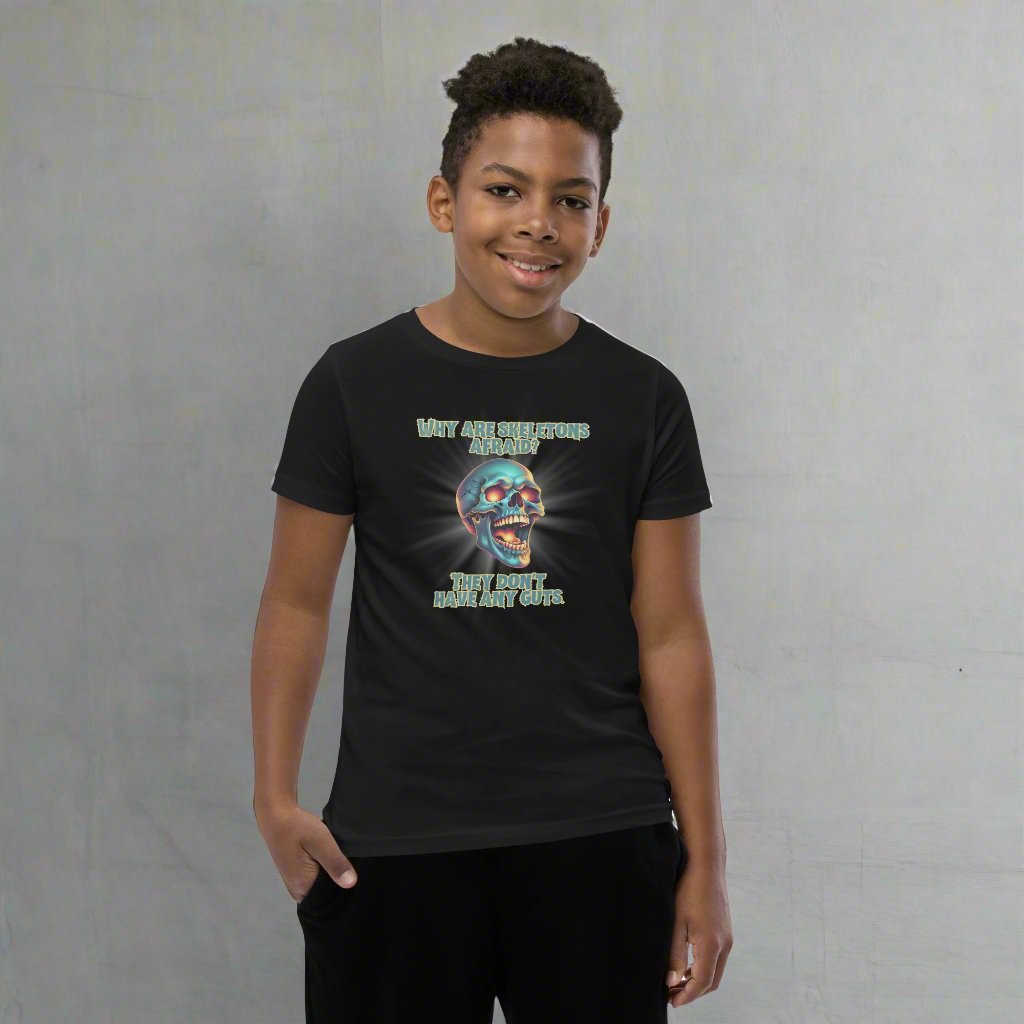 Halloween Skull Joke Shirt for Kids. This black tee features a laughing skull with the text "Why are skeletons afraid? They don't have any guts", by jaecrece.com