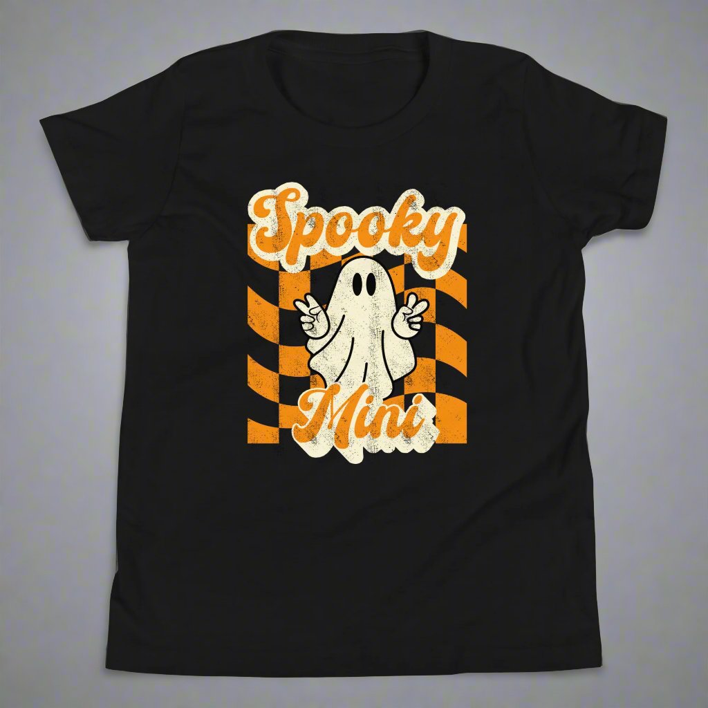 Spooky Mini Unisex Youth shirt, for girls and boys, featuring an orange checkerboard pattern with a cute ghost and the text Spooky Mini, by jaecrece