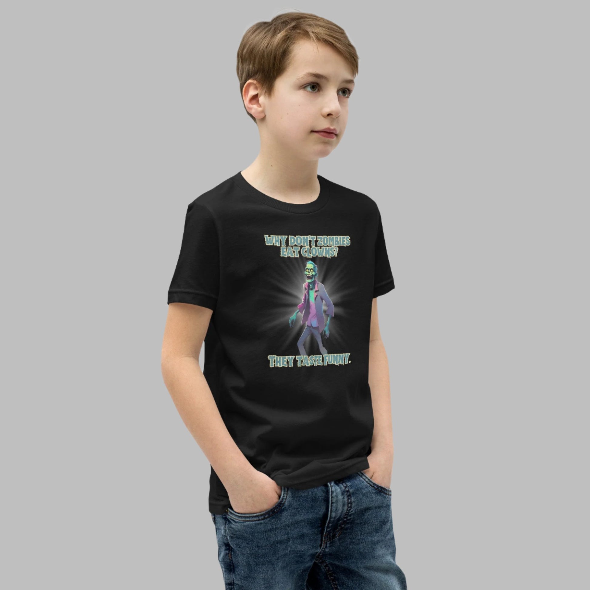 Halloween Zombie Joke Kids T-Shirt. This is a black tee with a picture of a laughing cartoon zombie. The text reads "Why don't zombies eat clowns? They taste funny", by jaecrece.com