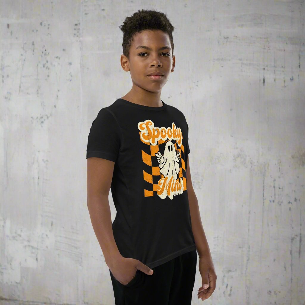 Spooky Mini Unisex Youth shirt, for girls and boys, featuring an orange checkerboard pattern with a cute ghost and the text Spooky Mini, by jaecrece