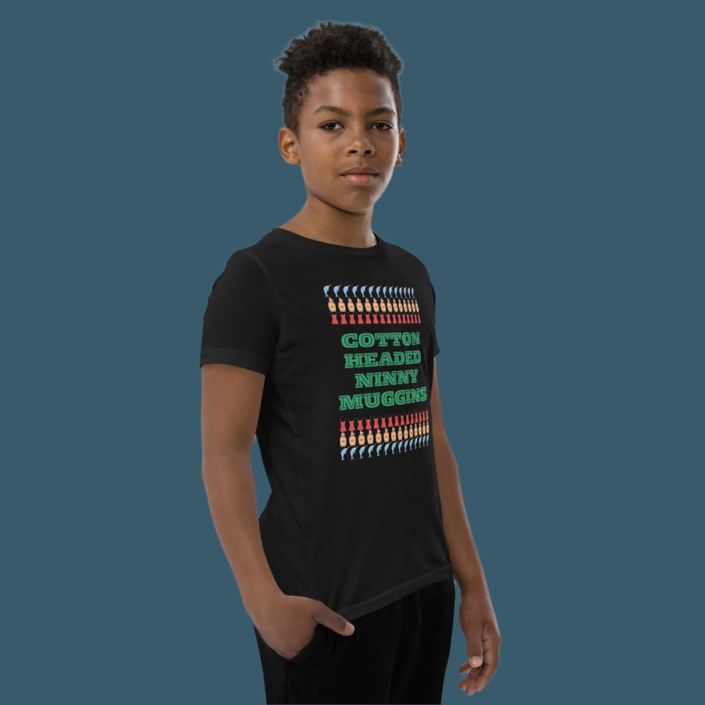 Kids holiday shirt with the iconic “Cotton Headed Ninny Muggins” quote from Elf, printed on a soft, breathable youth short sleeve tee. Designed with a relaxed unisex fit and durable pre-shrunk fabric, this Christmas t-shirt is perfect for festive fun, holiday events, and everyday winter wear. An excellent gift for young Elf fans and holiday enthusiasts.