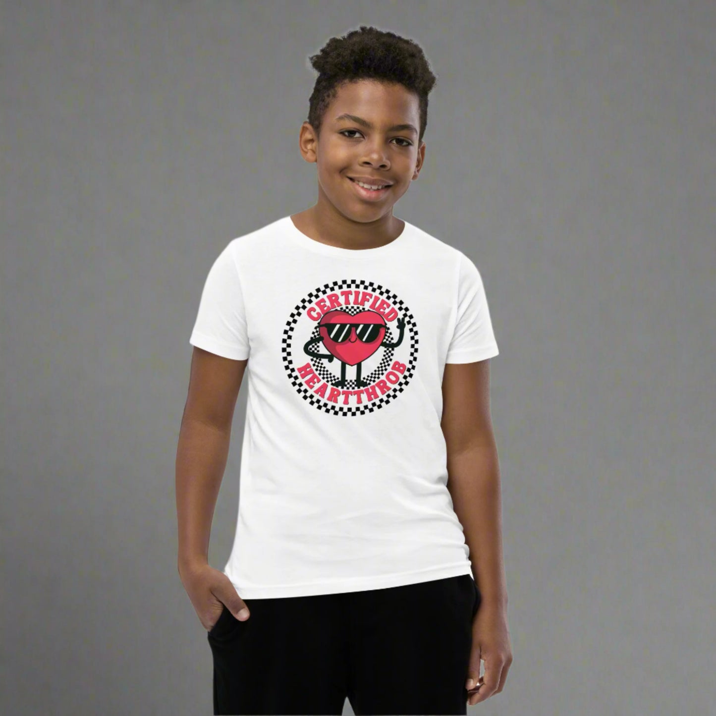 Image: Certified Heartthrob Tshirt. This Valentines Day tee for boys or girls is available in white or gray. It features a checker pattern ring, with a cartoon heart man wearing sunglasses, with the text Certified Heartthrob, by jaecrece
