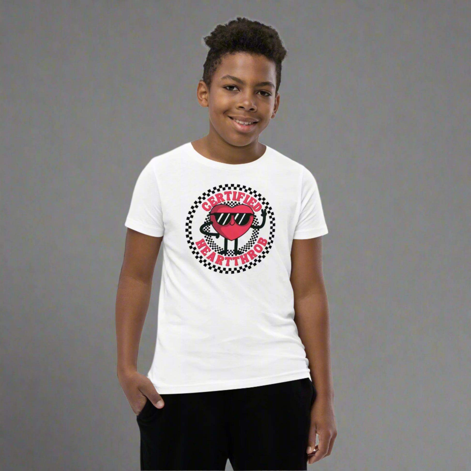 Image: Certified Heartthrob Tshirt. This Valentines Day tee for boys or girls is available in white or gray. It features a checker pattern ring, with a cartoon heart man wearing sunglasses, with the text Certified Heartthrob, by jaecrece