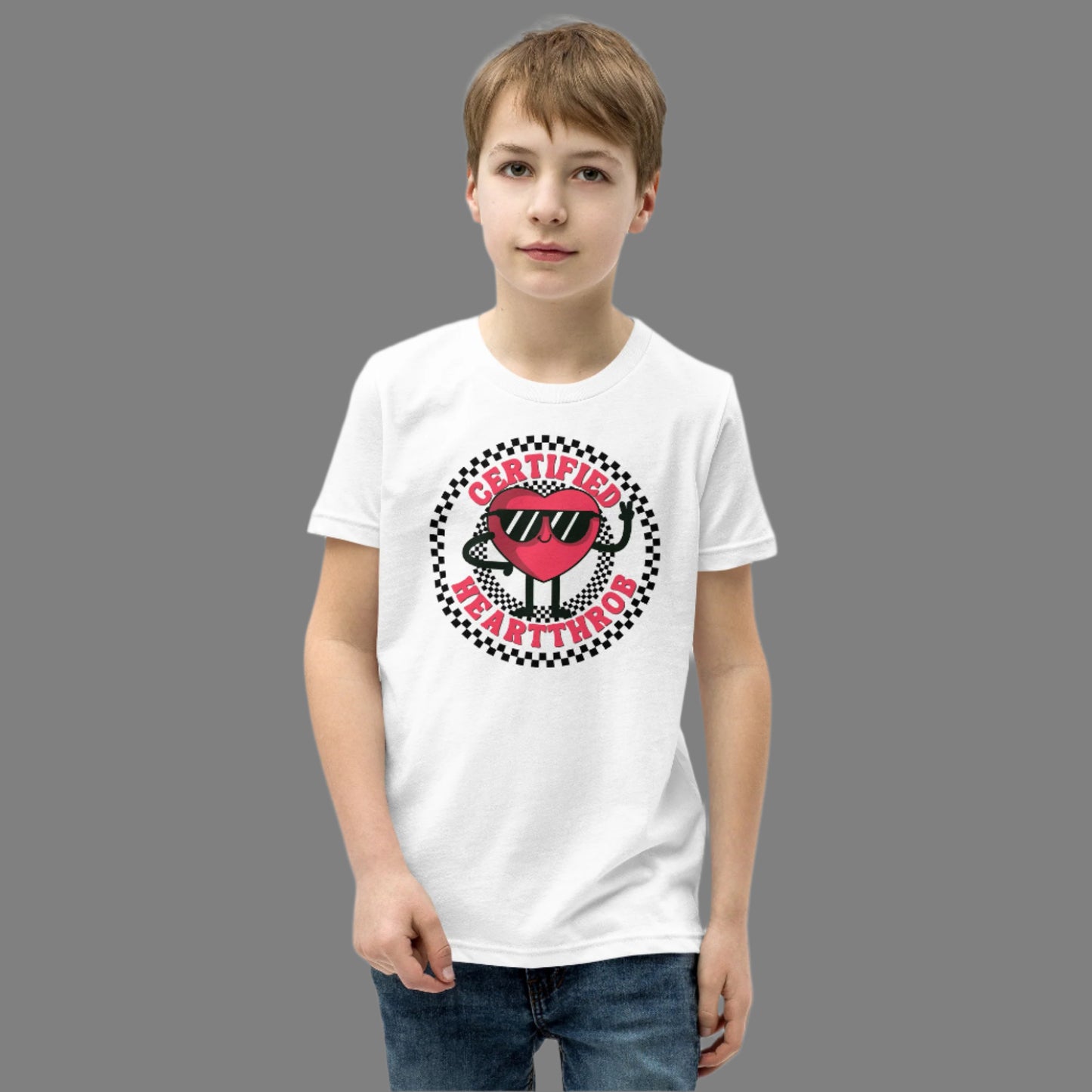 Image: Certified Heartthrob Tshirt. This Valentines Day tee for boys or girls is available in white or gray. It features a checker pattern ring, with a cartoon heart man wearing sunglasses, with the text Certified Heartthrob, by jaecrece