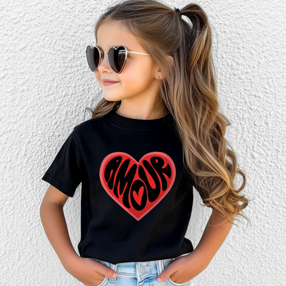 Amour Love Girls T-shirt in sizes XS–XL features a bold heart with the French word "Amour," perfect for Valentine's Day, Galentine’s events, or Paris-themed parties. This coquette-style girls Valentine shirt is a great gift for Francophile kids or a stylish daughter. Ideal for matching mommy and me outfits, this soft and comfy tee blends Paris fashion with soft girl aesthetic. Great for school parties, family photos, and tween outfits with heart.


