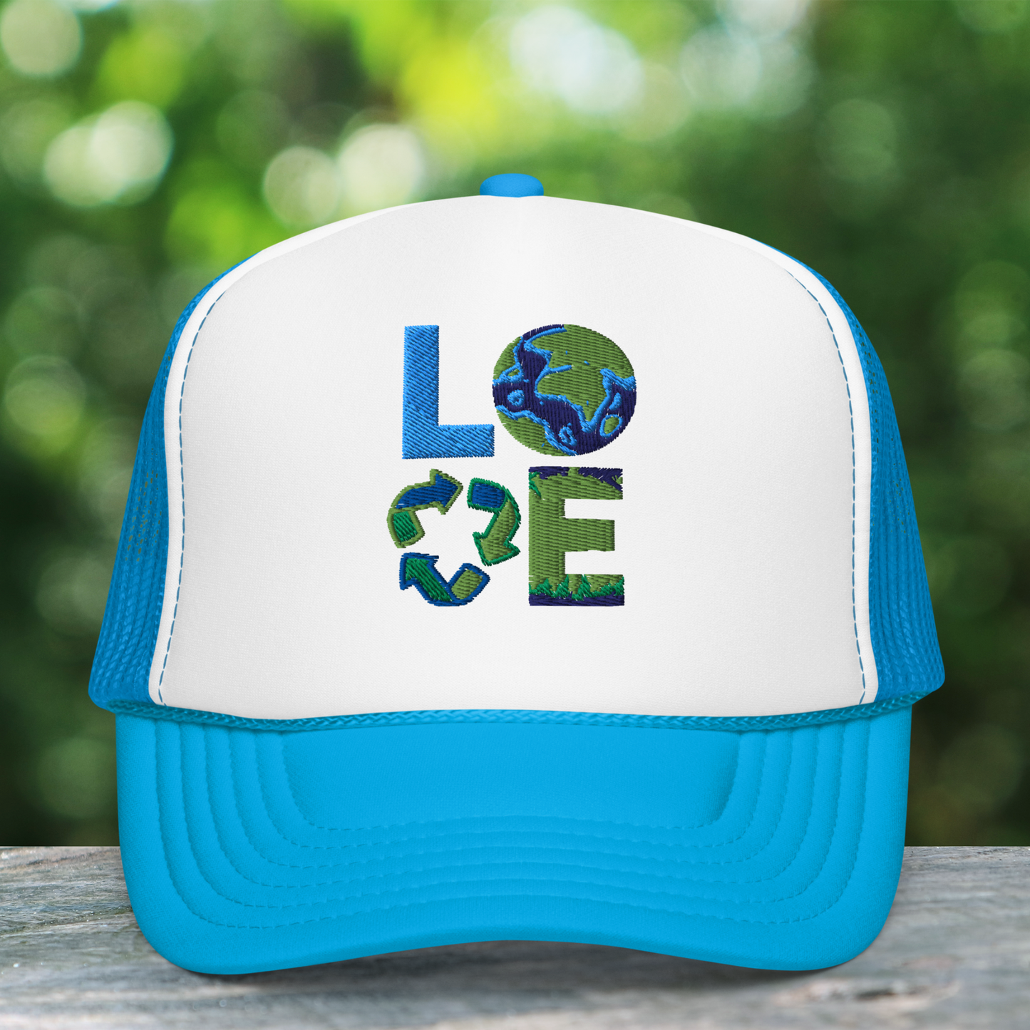 Image: Earth Day Foam Trucker Hat. This Save the Planet Unisex Hat has a teal blue bill and mesh back. The front of the baseball cap has LOVE embroidery to represent our planets oceans, plants and a commitment to reduce reuse and recycle, by jaecrece