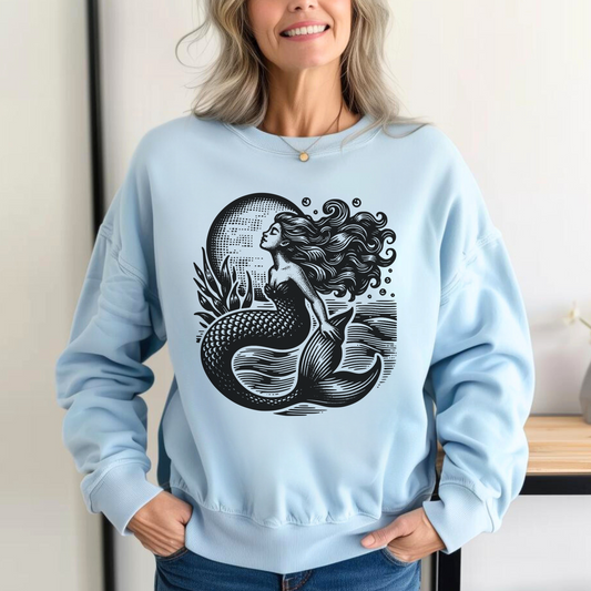 Image: Mermaid  Sweatshirt, Vintage Ocean Vibes Sweatshirt. Pullover crewneck features large black graphic with mermaid in front of the moon, in the ocean waves. Gift for women and teens who love a vintage ocean aesthetic and mermaidcore, by jaecrece