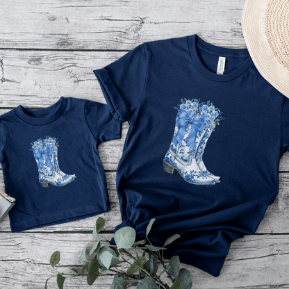 Let your toddler shine in this soft and stylish Blue Toile Floral Cowboy Boots Tee. Featuring classic toile de jouy cowgirl boots on a comfy toddler shirt, it’s great for country concerts, western parties, or just showing off a little southern sass. This toddler cowgirl tee is ideal for those who love the French aesthetic, soft girl fashion, and the bougie mama lifestyle. Makes a sweet gift for baby showers or toddler birthdays, too!
