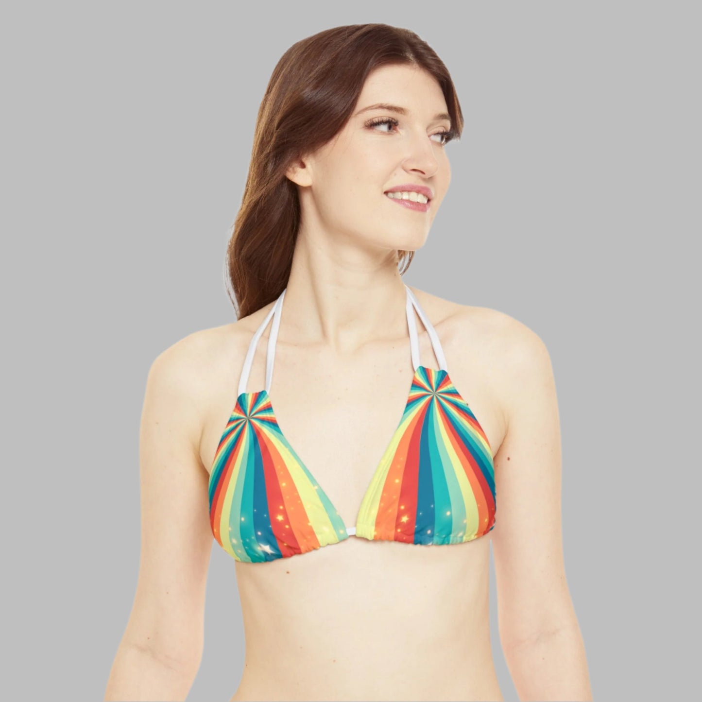 Image: A vibrant rainbow swirl print string bikini set with stars. 
Classic summer string bikini 
This womens bathing suit is ideal for the beach, pool, Pride events, festivals, raves and more. Colorful printed swimwear fashion for teens. By jaecrece