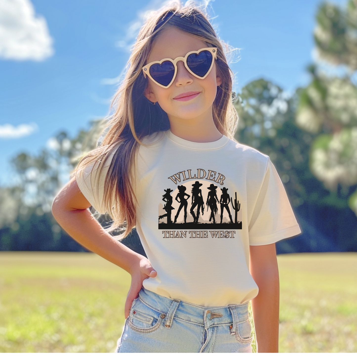 This Wilder than the West youth tee features a western silhouette scene with five fearless cowgirls and a cactus-filled sunset. Made for girls who ride wild and love the desert, rodeo, or state fair life. A graphic wear women and girls match option that coordinates with toddler and adult sizes. Ideal for coastal, southern, or coquette looks and bachelorette weekend outfits with mama mini matching flair.

