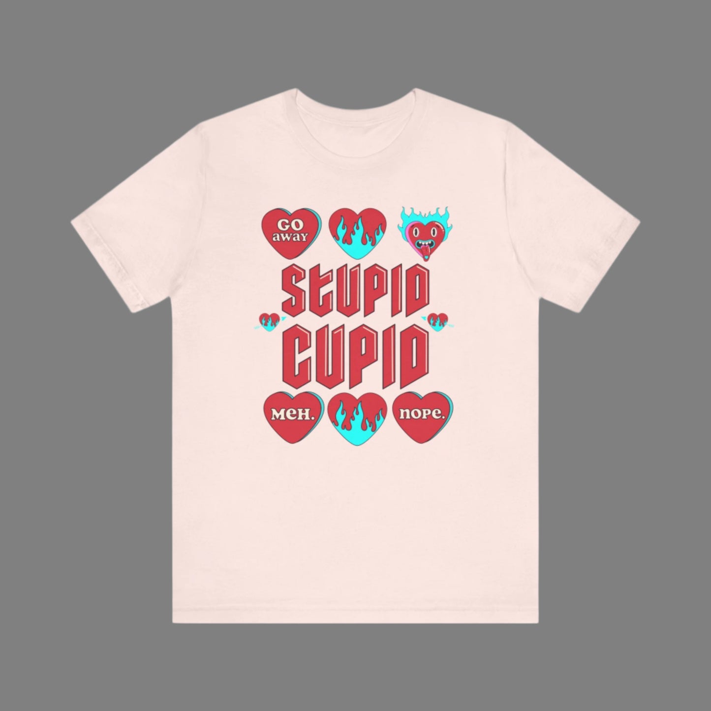 Image: Stupid Cupid Anti Valentines Day T-shirt, Unisex adult breakup shirt- this tee has large red 90s style text that reads Stupid Cupid, surrounded by conversation hearts that are on fire, or say Go Away, Meh, Nope. Great for divorce, by jaecrece