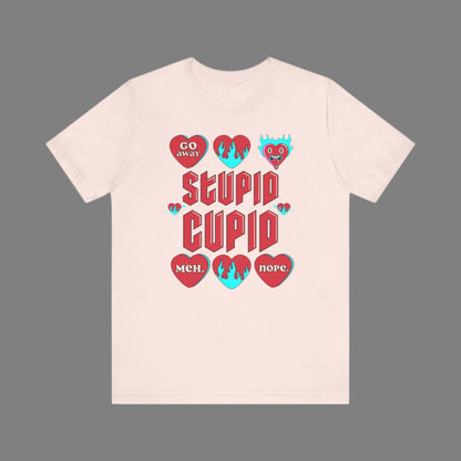 Image: Stupid Cupid Anti Valentines Day T-shirt, Unisex adult breakup shirt- this tee has large red 90s style text that reads Stupid Cupid, surrounded by conversation hearts that are on fire, or say Go Away, Meh, Nope. Great for divorce, by jaecrece