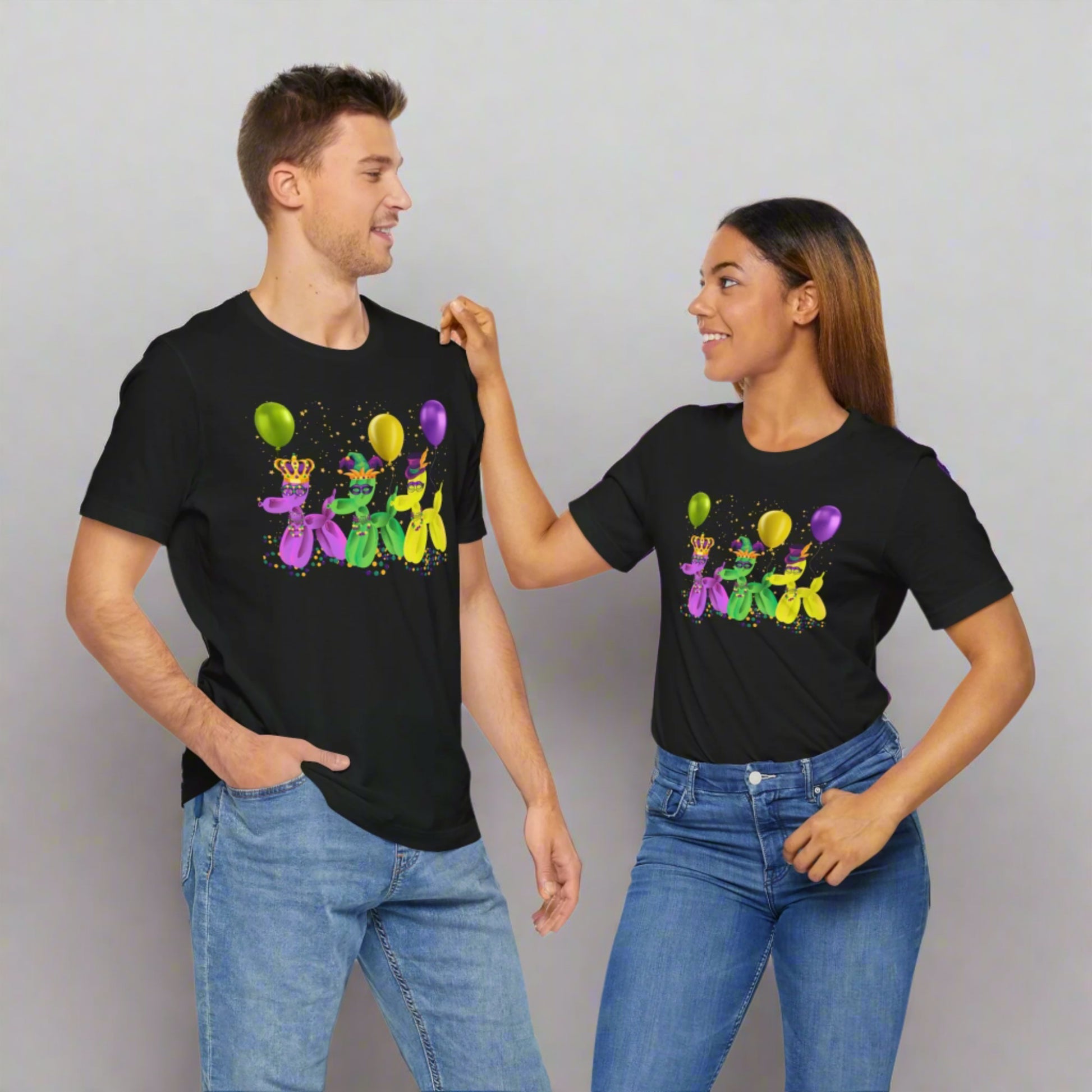 Image: Mardi Gras Balloon Dog Adult Shirt. This New Orleans Carnival tee features three balloons dogs, wearing Mardi Gras masks and hats. They have beads and balloons with confetti, by jaecrece