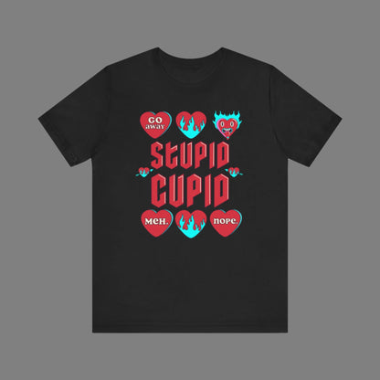 Image: Stupid Cupid Anti Valentines Day T-shirt, Unisex adult breakup shirt- this tee has large red 90s style text that reads Stupid Cupid, surrounded by conversation hearts that are on fire, or say Go Away, Meh, Nope. Great for divorce, by jaecrece