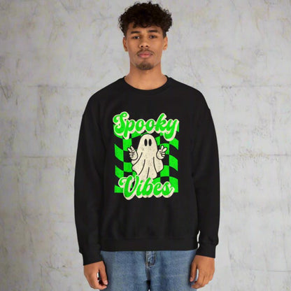 Black Halloween Unisex sweatshirt, featuring a green checkboard pattern, cute ghost giving the peace sign, and the text Spooky vibes, by jaecrece