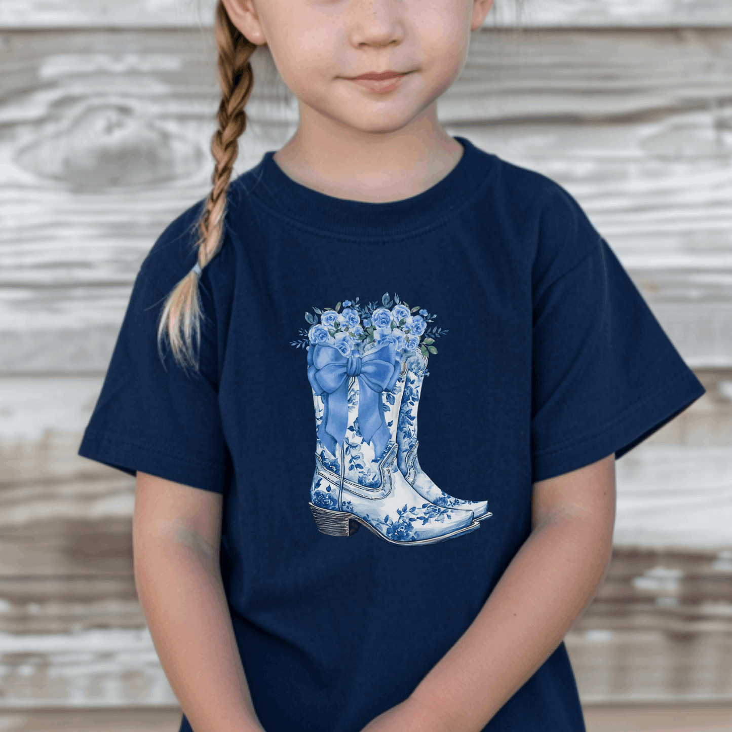 This Blue Toile Floral Cowboy Boots Toddler Tee is perfect for little ones who love western style with a soft girl twist. Featuring a detailed blue toile de jouy pattern and chic cowgirl boots, this toddler graphic shirt blends classic French aesthetic with Texas charm. Ideal for rodeo days, Western-themed parties, or everyday adventures. A must-have for fans of bougie mama style, blue toile fashion, and toddler western outfits.