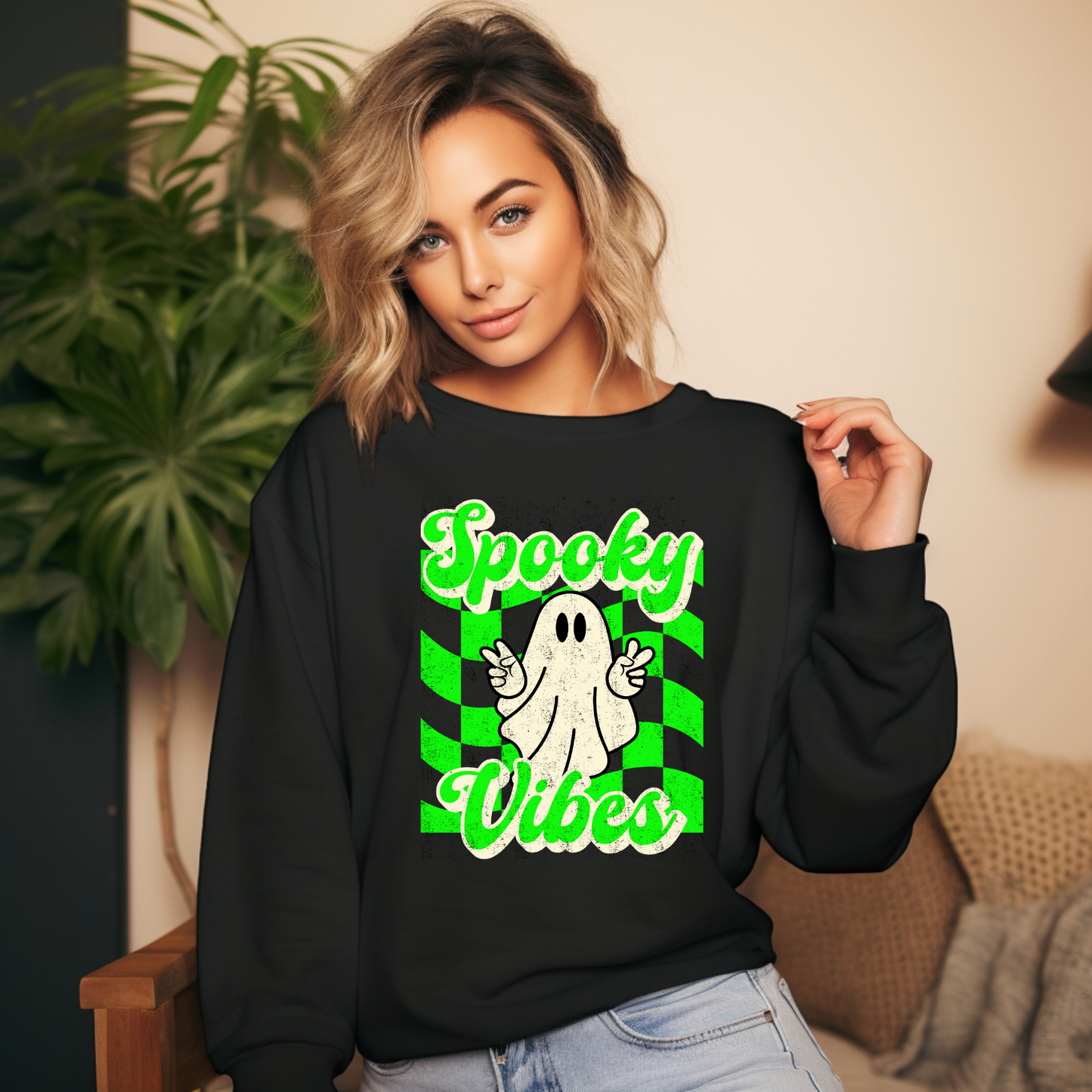 Black Halloween Unisex sweatshirt, featuring a green checkboard pattern, cute ghost giving the peace sign, and the text Spooky vibes, by jaecrece