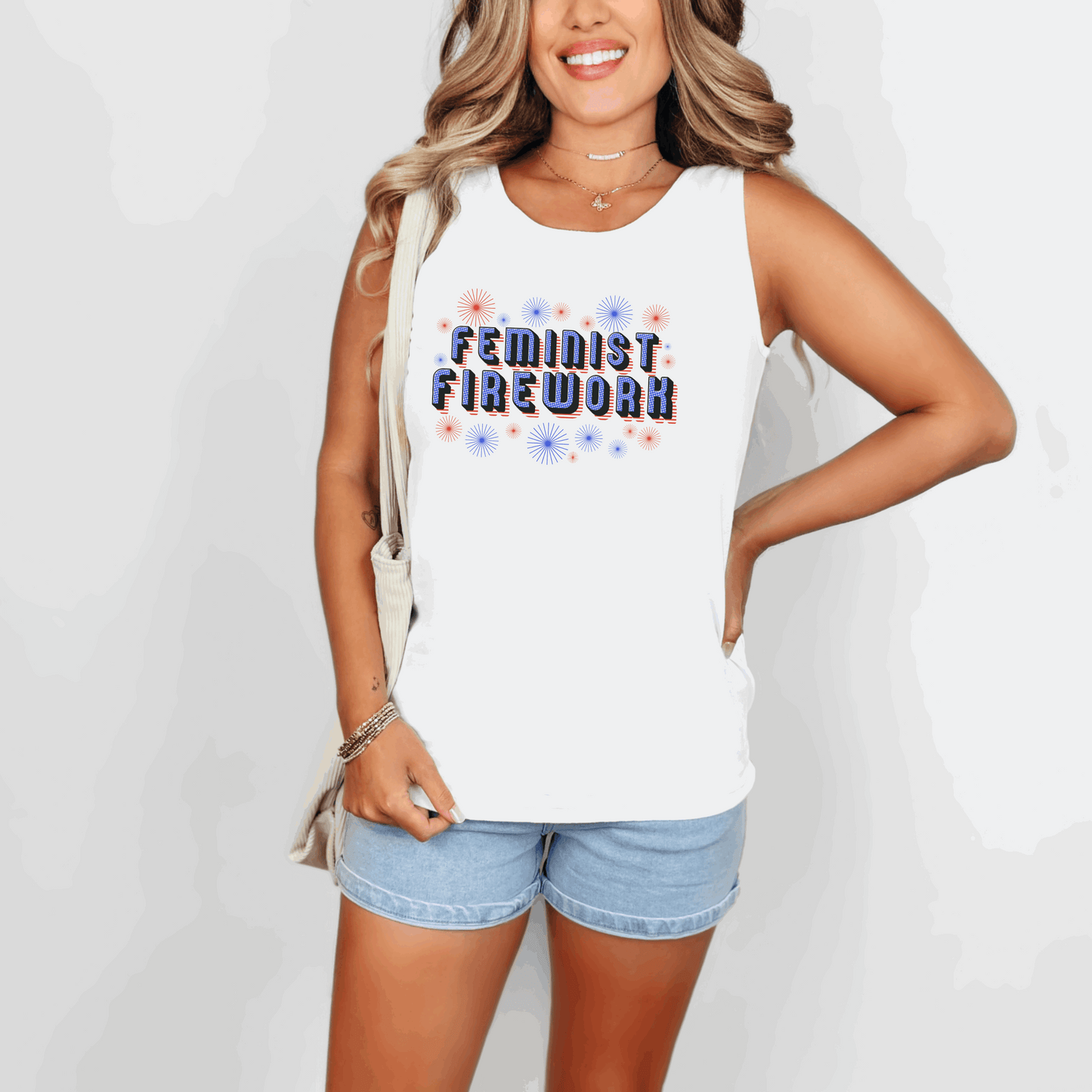 Feminist Firework tank top featuring retro red, white, and blue lettering with a firework burst in the background. Made for 4th of July celebrations, protests, or summer festivals, this patriotic women's rights shirt is perfect for activists, allies, and proud feminists. Available in white, ivory, and chambray Comfort Colors fabric, this relaxed fit tank is a bold choice for warm-weather wear with purpose.

