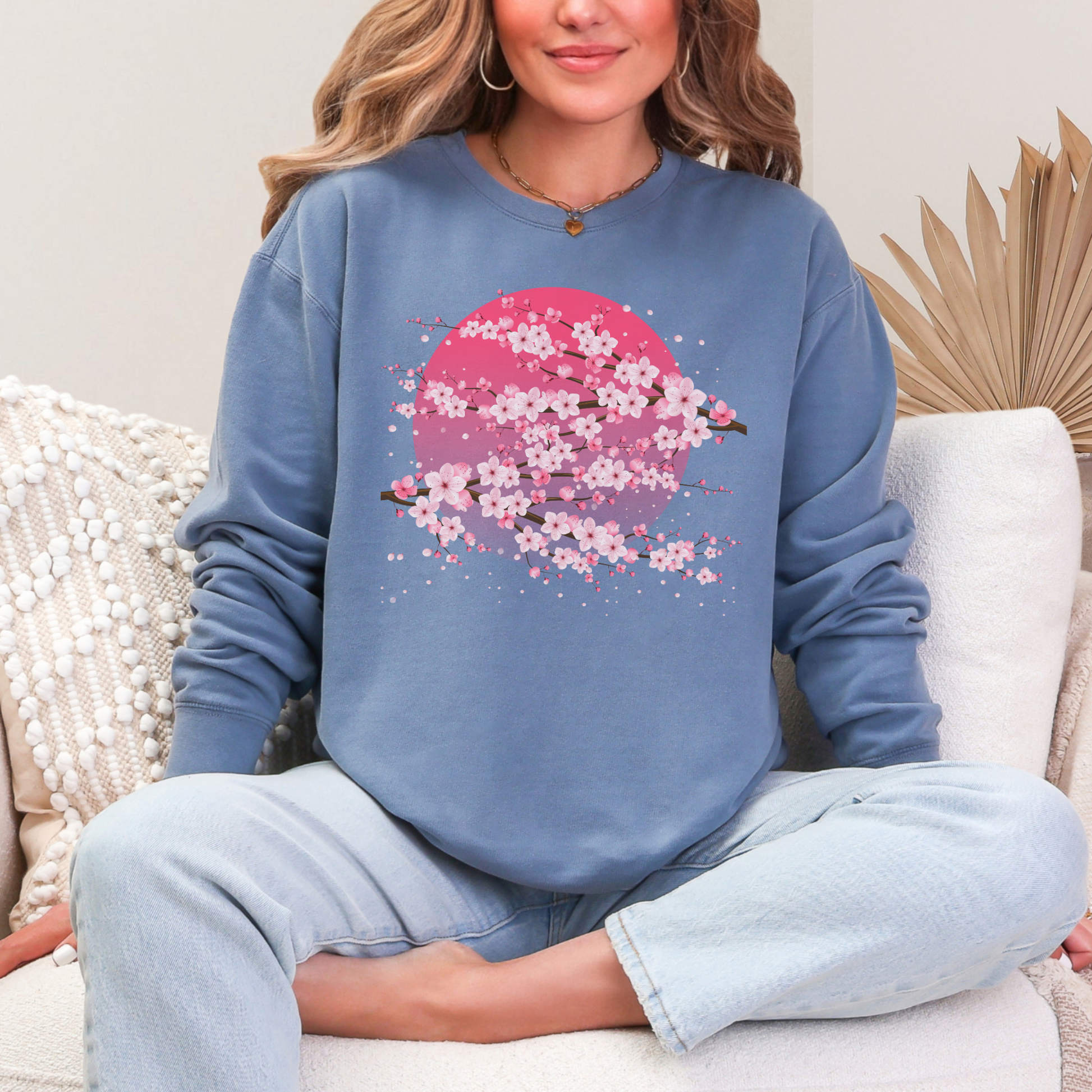 Image: Japanese Cherry Blossom Womens Comfort Colors 1466 sweatshirt featuring a serene pink moon design with delicate Japanese cherry blossom (sakura) branches. This cozy, vintage-washed crewneck offers a relaxed fit, perfect for casual wear. Inspired by Japanese aesthetics, this sakura sweatshirt captures the beauty of nature and the fleeting elegance of cherry blossoms under a moonlit sky. Ideal for spring outfits, hanami festivals, or anyone who loves Japanese-inspired fashion and celestial designs.