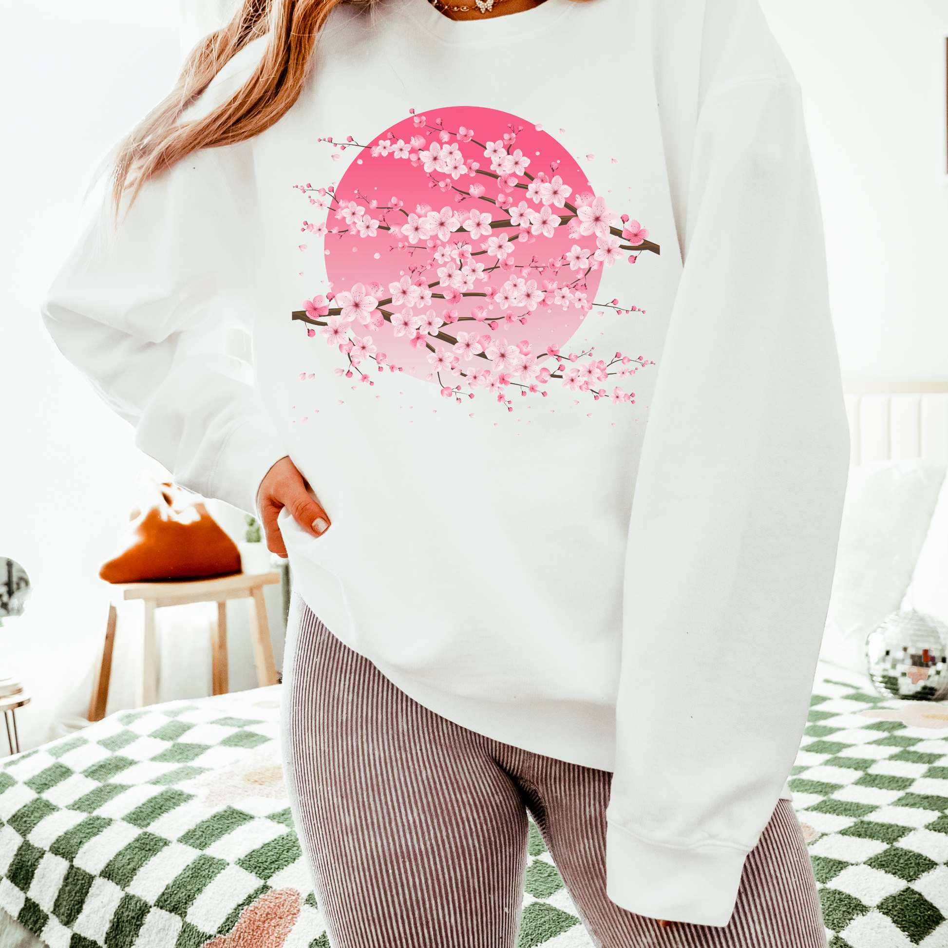 Image: Japanese Cherry Blossom Womens Comfort Colors 1466 sweatshirt featuring a serene pink moon design with delicate Japanese cherry blossom (sakura) branches. This cozy, vintage-washed crewneck offers a relaxed fit, perfect for casual wear. Inspired by Japanese aesthetics, this sakura sweatshirt captures the beauty of nature and the fleeting elegance of cherry blossoms under a moonlit sky. Ideal for spring outfits, hanami festivals, or anyone who loves Japanese-inspired fashion and celestial designs.