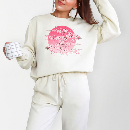 Image: Japanese Cherry Blossom Womens Comfort Colors 1466 sweatshirt featuring a serene pink moon design with delicate Japanese cherry blossom (sakura) branches. This cozy, vintage-washed crewneck offers a relaxed fit, perfect for casual wear. Inspired by Japanese aesthetics, this sakura sweatshirt captures the beauty of nature and the fleeting elegance of cherry blossoms under a moonlit sky. Ideal for spring outfits, hanami festivals, or anyone who loves Japanese-inspired fashion and celestial designs.