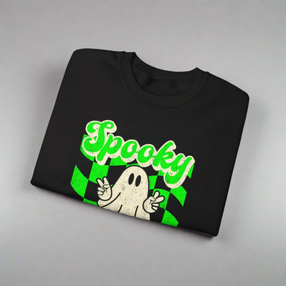 Black Halloween Unisex sweatshirt, featuring a green checkboard pattern, cute ghost giving the peace sign, and the text Spooky vibes, by jaecrece