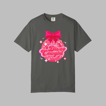Disco Cowgirl tee for women in Comfort Colors is designed with a glittery pink disco ball, hot pink bow, and bright lettering. Ideal for matching party outfits, this retro western shirt is a cute coquette option for bachelorettes, rodeos, or girls' weekends. Available in S–4XL in multiple neutral shades for a flattering, oversized fit.