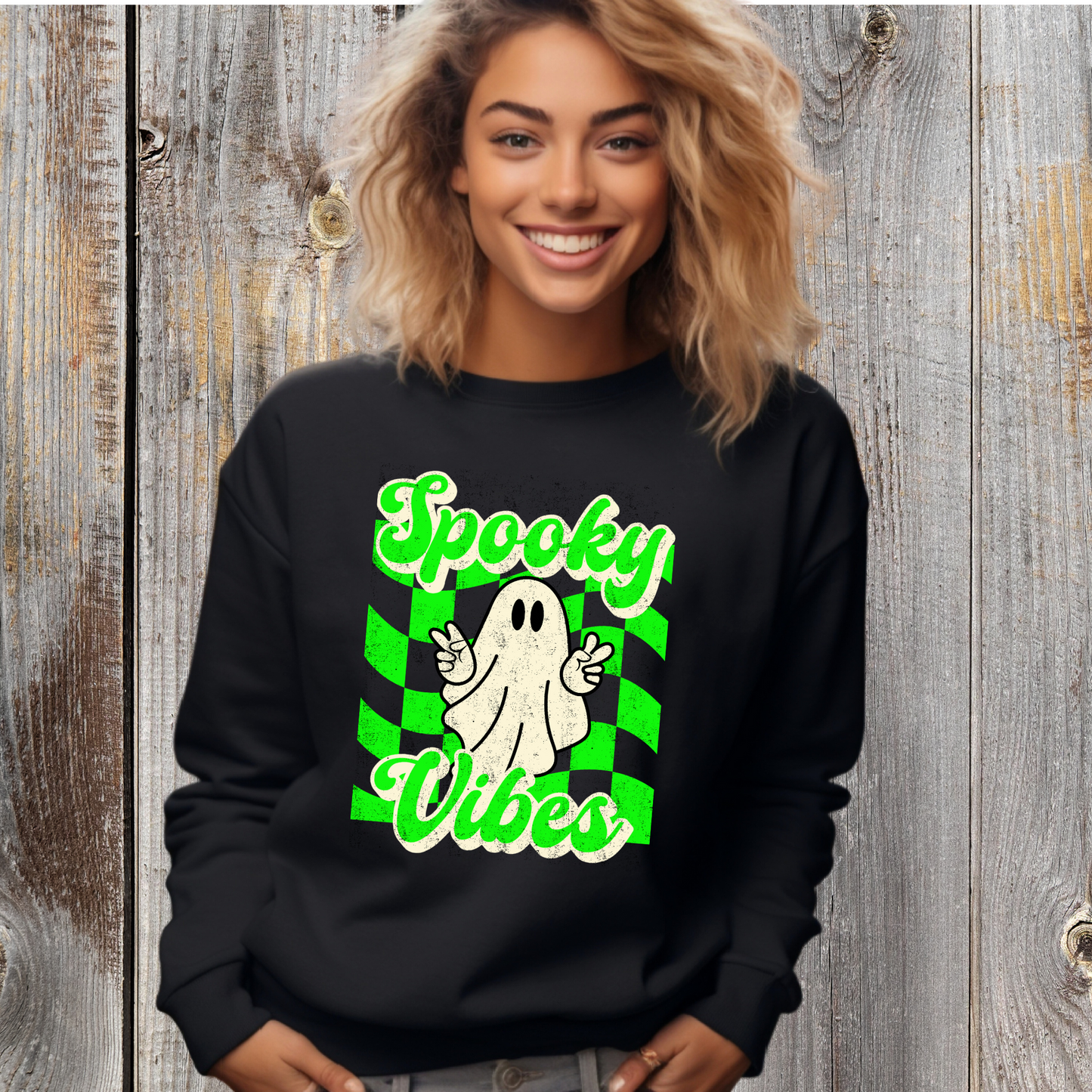 Black Halloween Unisex sweatshirt, featuring a green checkboard pattern, cute ghost giving the peace sign, and the text Spooky vibes, by jaecrece