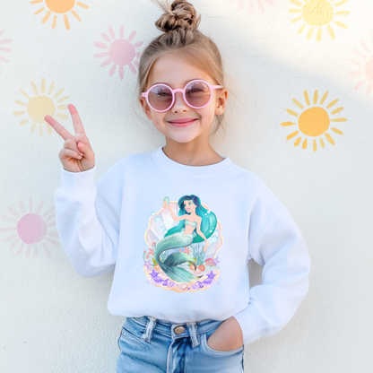 Image: Mermaid Sweatshirt for Little Girls. Pullover crewneck sweatshirt features a mermaid with blue hair and scales, swimming in a shell, with bubbles and seashells. This mermaidcore sweater is available in white, navy and hot pink, by jaecrece