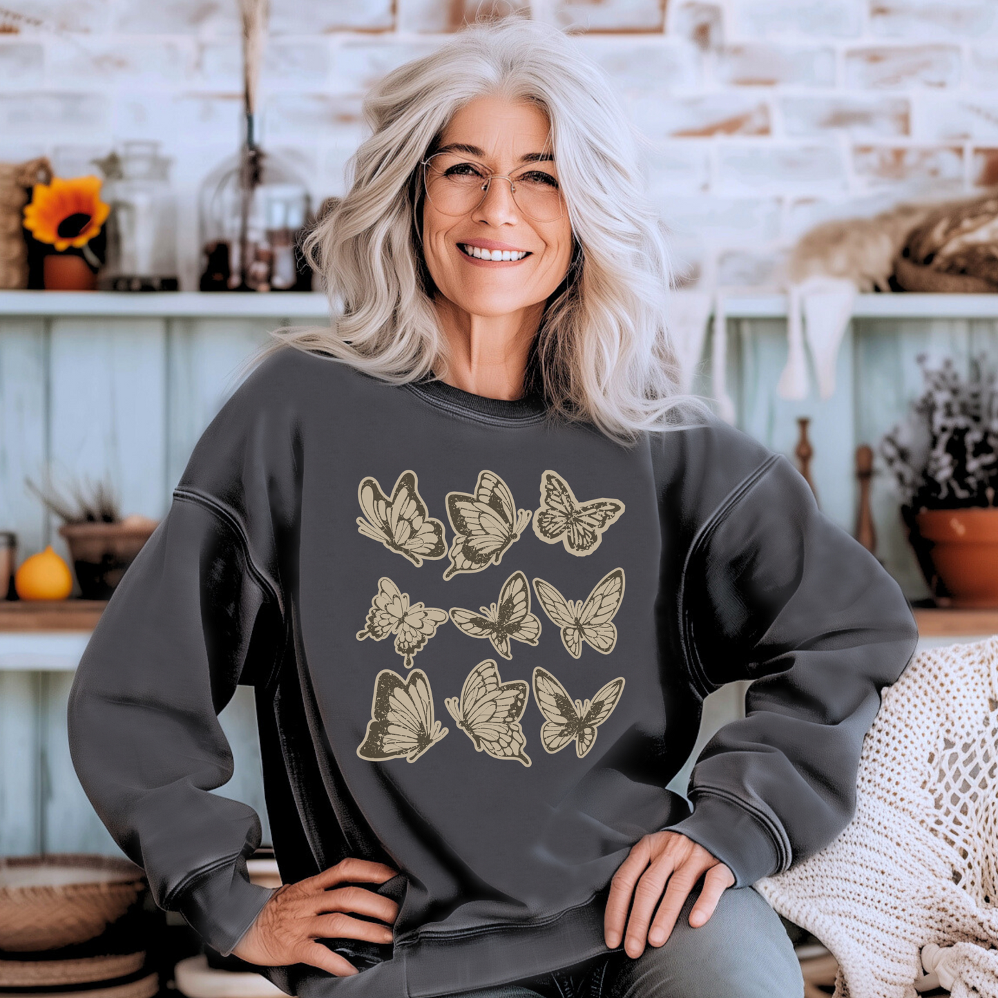 Image: Vintage style butterfly sweatshirt featuring a cozy crewneck pullover design. Adorned with 9 intricately detailed butterflies in a scrapbook inspired brown and cream paper texture, adding a rustic and artistic touch. Perfect for casual wear and nature lovers, by Jaecrece.