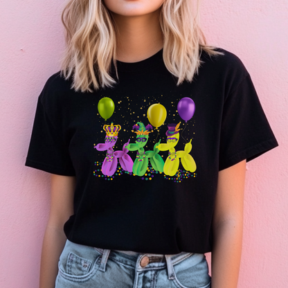 Image: Mardi Gras Balloon Dog Adult Shirt. This New Orleans Carnival tee features three balloons dogs, wearing Mardi Gras masks and hats. They have beads and balloons with confetti, by jaecrece