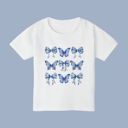 Blue Toile toddler tee for girls features a classic butterfly and bow motif in soft blue hues, perfect for fans of cottagecore, Texas coquette trends, and coastal cowgirl style. Designed for comfort and charm, this cute spring shirt for toddlers is ideal for everyday play or family matching moments. Sizes 2T to 6T make it easy to twin with older siblings or moms. An aesthetic, versatile gift for fashionable little ones, by jaecrece.
