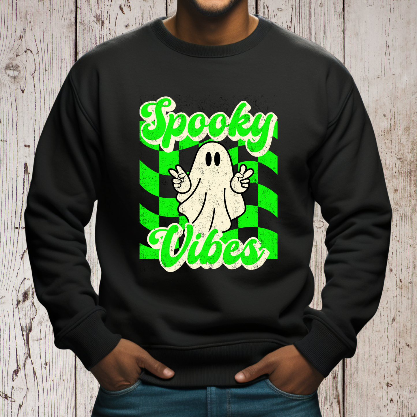 Black Halloween Unisex sweatshirt, featuring a green checkboard pattern, cute ghost giving the peace sign, and the text Spooky vibes, by jaecrece