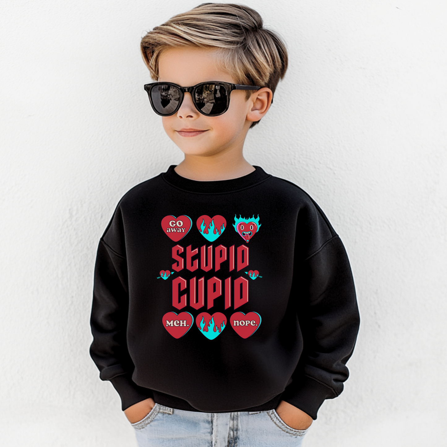 Image: Stupid Cupid Anti Valentines Day T-shirt for Kids. This sweatshirt is for girls and boys with red 90s style text that reads Stupid Cupid, with conversation hearts that are on fire, or say Go Away, Meh, Nope. Great for school party, by jaecrece