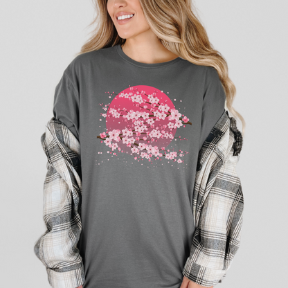 Image: A pink cherry blossom t-shirt featuring a delicate sakura tree design. The soft, durable fabric offers comfort, while the classic fit makes it versatile for any occasion. Perfect for springtime celebrations, Japanese aesthetic lovers, and those who appreciate kawaii fashion. Ideal as a gift for teens and adults. 