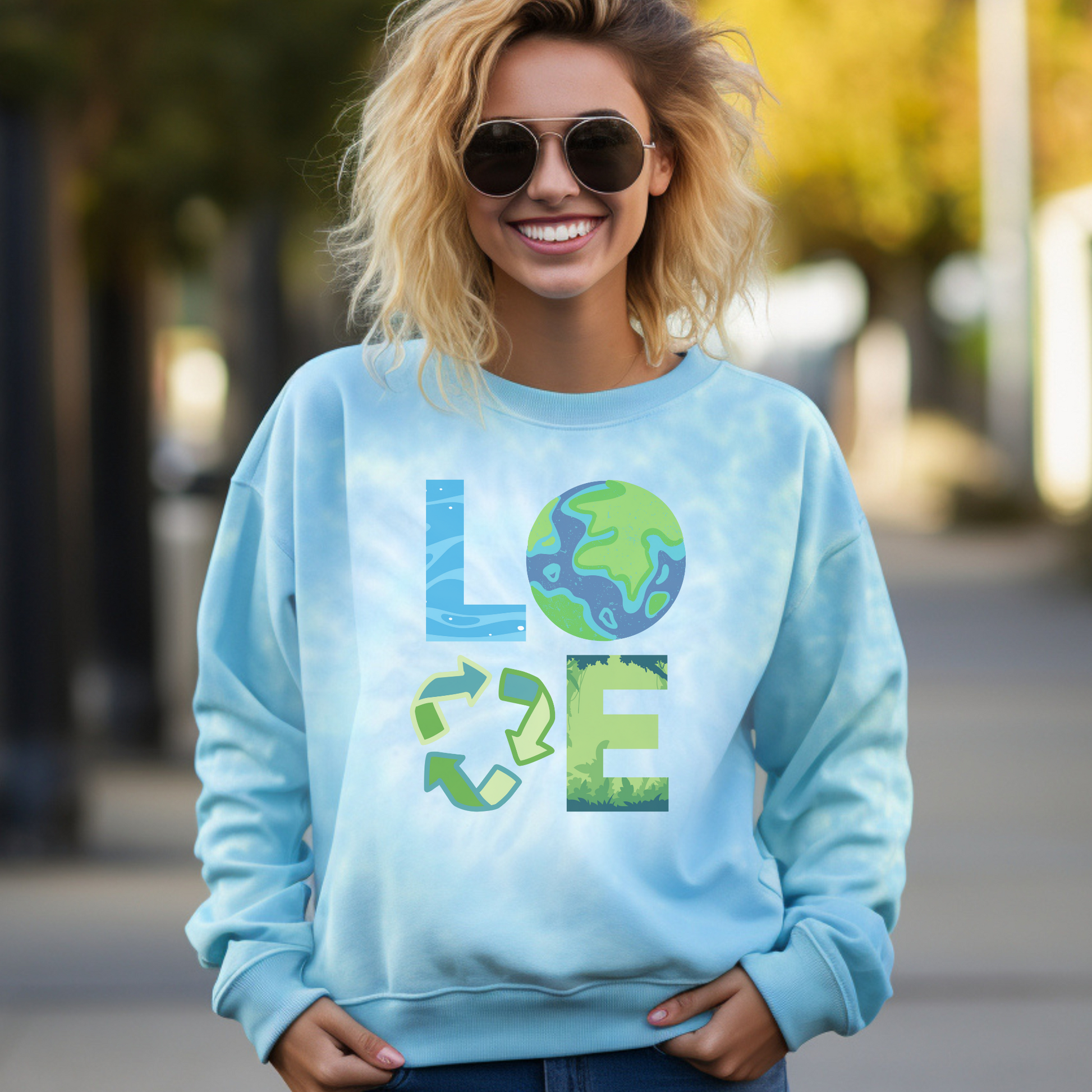 Image: LOVE Earth Blue Tie Dye Sweatshirt, perfect for Earth Day, the letters in LOVE represent our planets oceans, Mother Earth, Reduce, Reuse Recycle, and our plants and trees. This graphic is printed on a blue tie dye crewneck sweatshirt, by jaecrece