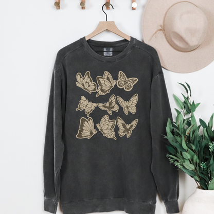 Image: Vintage style butterfly sweatshirt featuring a cozy crewneck pullover design. Adorned with 9 intricately detailed butterflies in a scrapbook inspired brown and cream paper texture, adding a rustic and artistic touch. Perfect for casual wear and nature lovers, by Jaecrece.