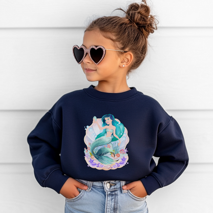 Image: Mermaid Sweatshirt for Little Girls. Pullover crewneck sweatshirt features a mermaid with blue hair and scales, swimming in a shell, with bubbles and seashells. This mermaidcore sweater is available in white, navy and hot pink, by jaecrece