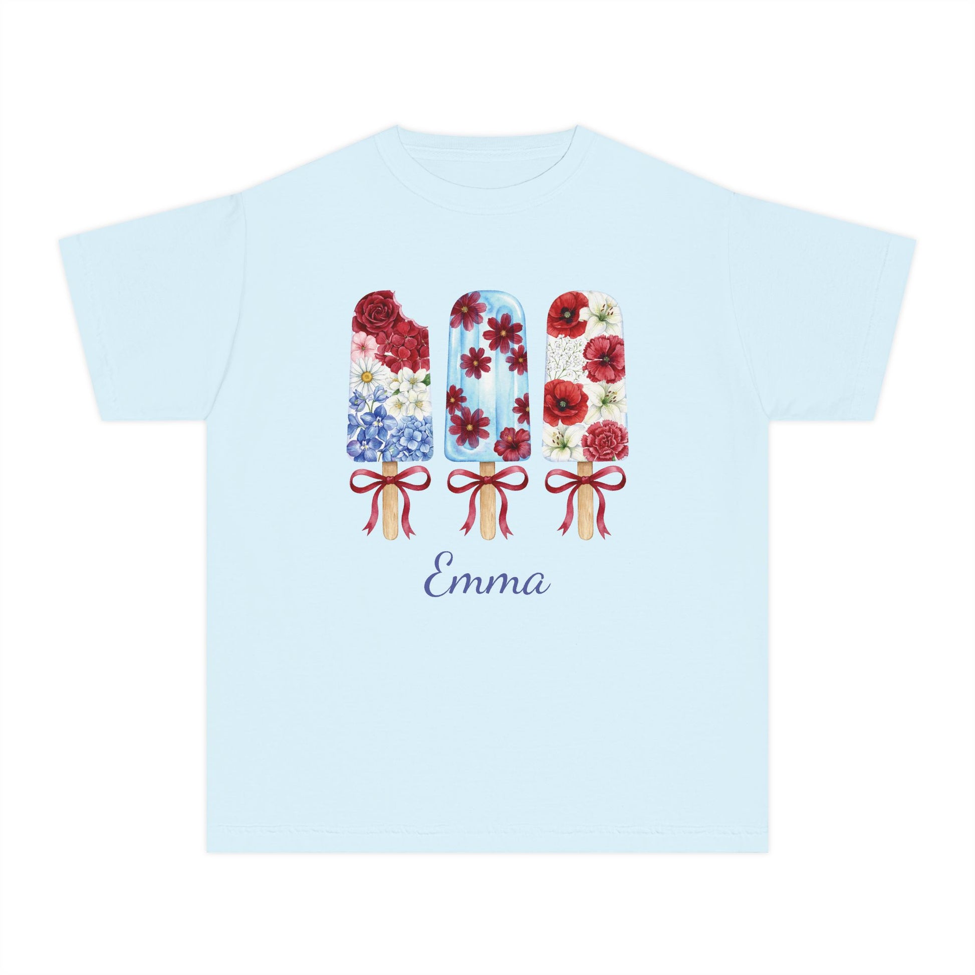 A light blue short sleeve crewneck t-shirt featuring a graphic of three popsicles filled with red and blue floral patterns, and the name 'Emma' personalized below in a dark blue script font.
