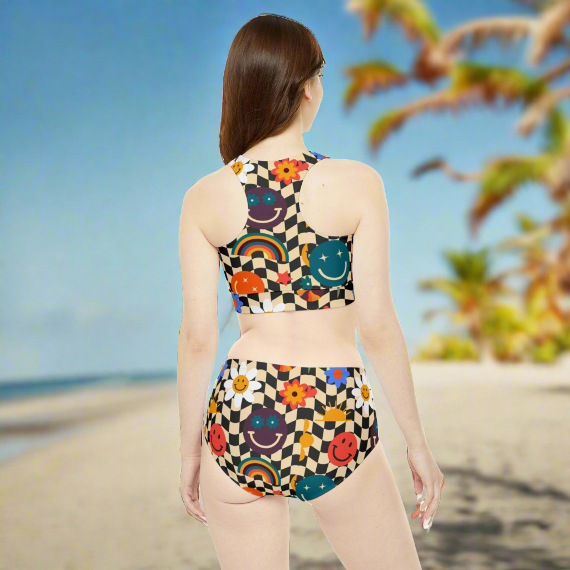 Smiley Face Checkerboard Womens Two Piece Sporty Bikini. This cute athletic ladies bathing suit features a black and khaki checkerboard background, with smiley face, rainbow and daisy graphics. It is perfect for swimming, vacations and athletic events. By jaecrece.com