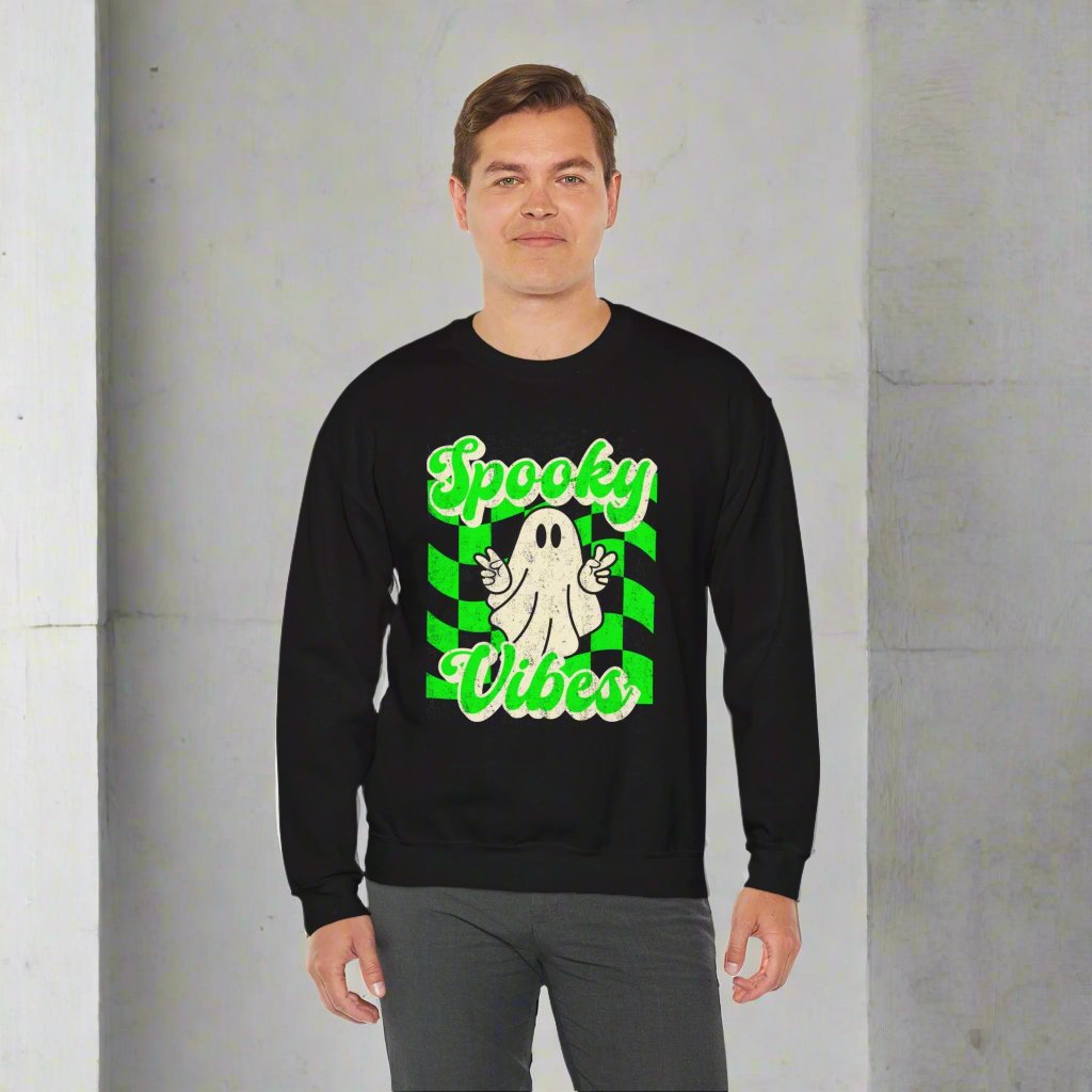 Black Halloween Unisex sweatshirt, featuring a green checkboard pattern, cute ghost giving the peace sign, and the text Spooky vibes, by jaecrece