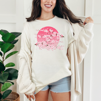 Image: A pink cherry blossom t-shirt featuring a delicate sakura tree design. The soft, durable fabric offers comfort, while the classic fit makes it versatile for any occasion. Perfect for springtime celebrations, Japanese aesthetic lovers, and those who appreciate kawaii fashion. Ideal as a gift for teens and adults. 