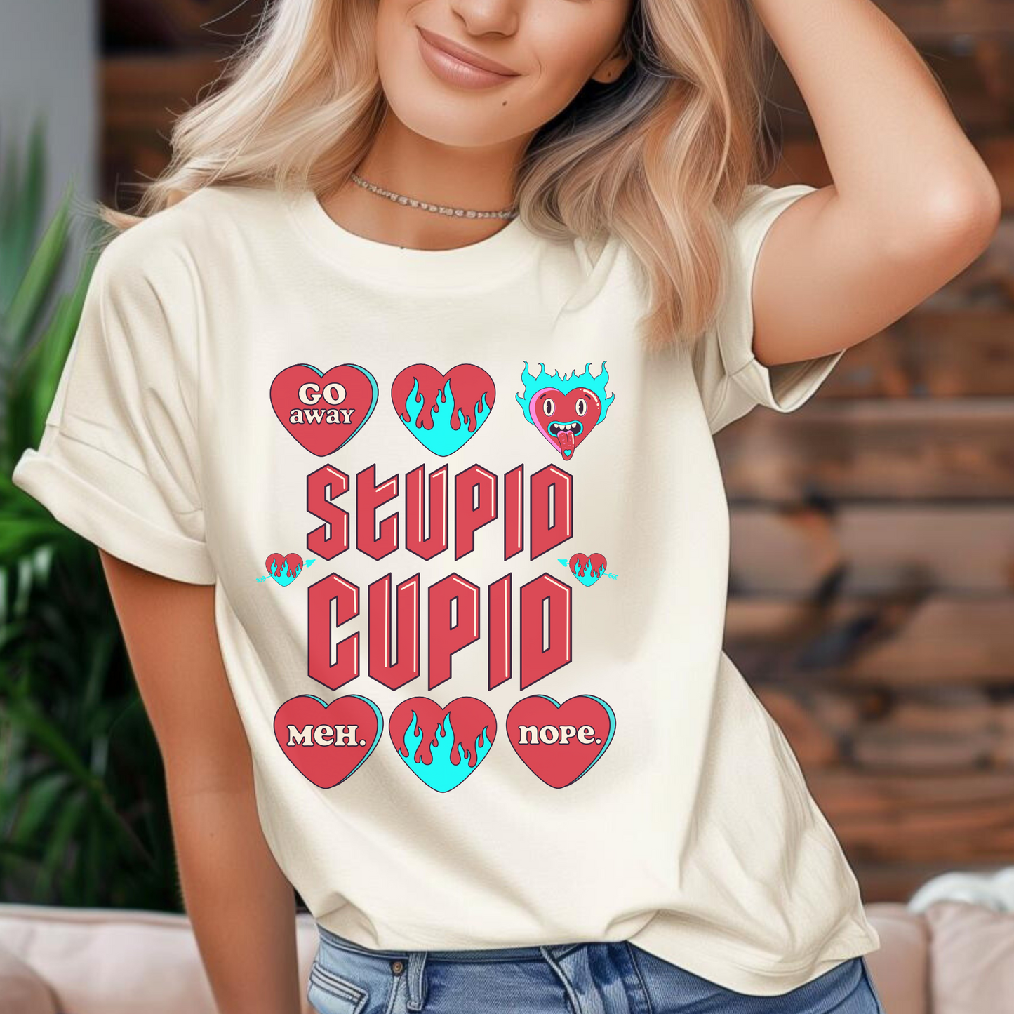 Image: Stupid Cupid Anti Valentines Day T-shirt, Unisex adult breakup shirt- this tee has large red 90s style text that reads Stupid Cupid, surrounded by conversation hearts that are on fire, or say Go Away, Meh, Nope. Great for divorce, by jaecrece