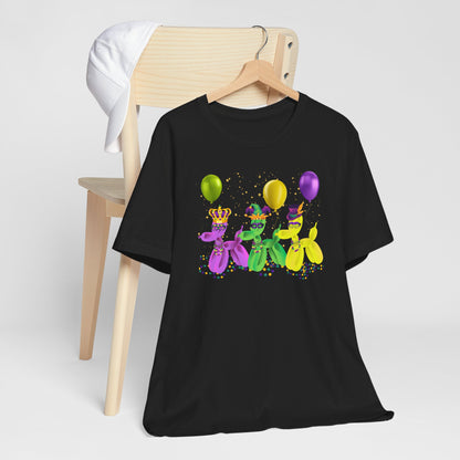 Image: Mardi Gras Balloon Dog Adult Shirt. This New Orleans Carnival tee features three balloons dogs, wearing Mardi Gras masks and hats. They have beads and balloons with confetti, by jaecrece