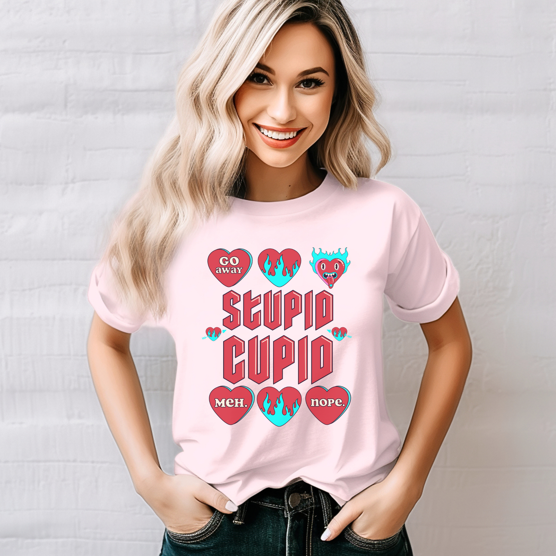 Image: Stupid Cupid Anti Valentines Day T-shirt, Unisex adult breakup shirt- this tee has large red 90s style text that reads Stupid Cupid, surrounded by conversation hearts that are on fire, or say Go Away, Meh, Nope. Great for divorce, by jaecrece