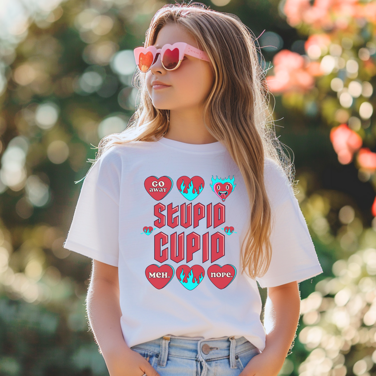 Image: Stupid Cupid Anti Valentines Day T-shirt for Kids. This sweatshirt is for girls and boys with red 90s style text that reads Stupid Cupid, with conversation hearts that are on fire, or say Go Away, Meh, Nope. Great for school party, by jaecrece