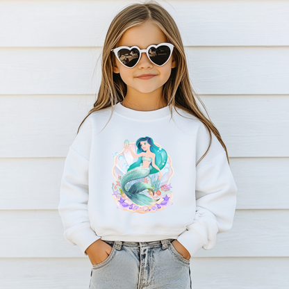 Image: Mermaid Sweatshirt for Little Girls. Pullover crewneck sweatshirt features a mermaid with blue hair and scales, swimming in a shell, with bubbles and seashells. This mermaidcore sweater is available in white, navy and hot pink, by jaecrece