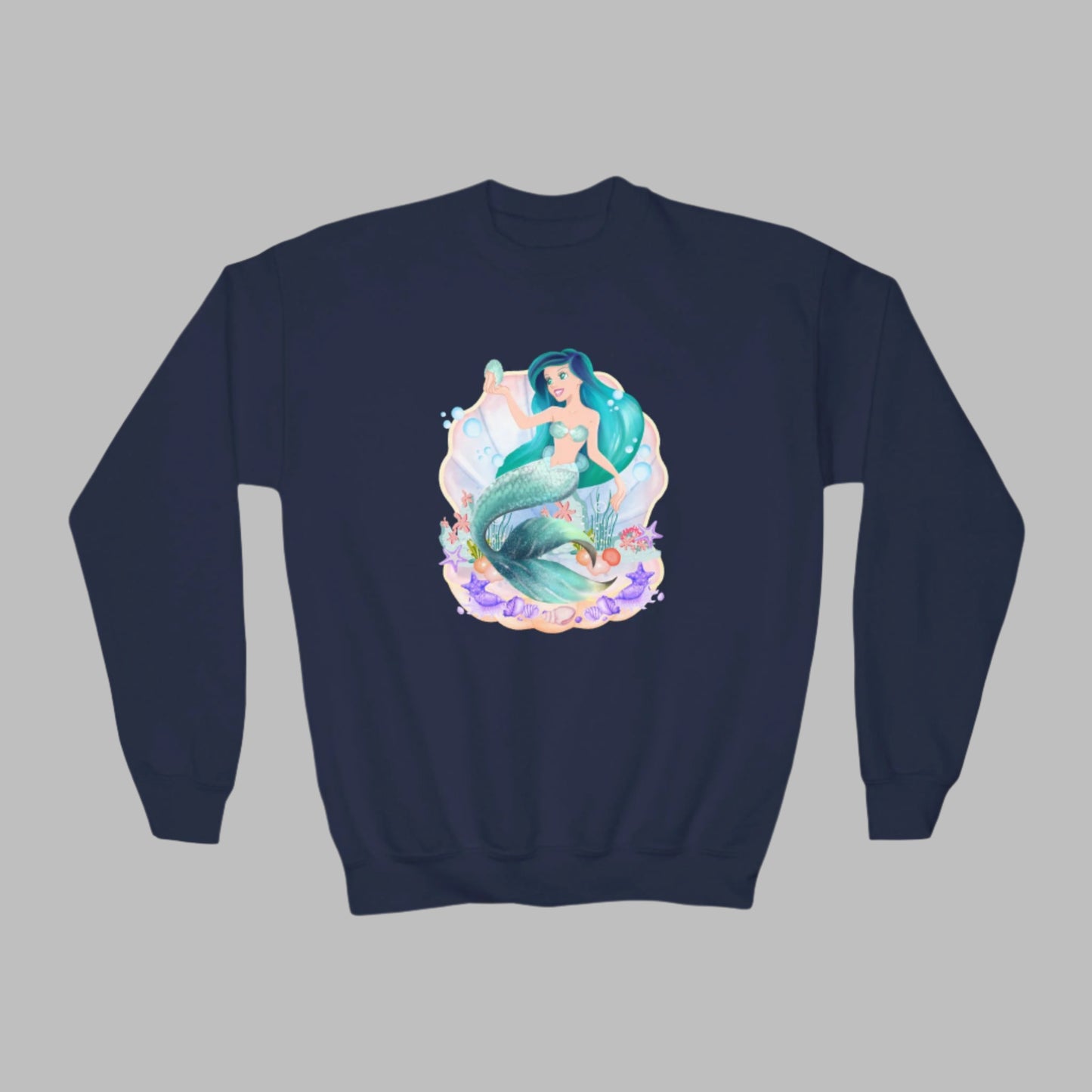 Image: Mermaid Sweatshirt for Little Girls. Pullover crewneck sweatshirt features a mermaid with blue hair and scales, swimming in a shell, with bubbles and seashells. This mermaidcore sweater is available in white, navy and hot pink, by jaecrece