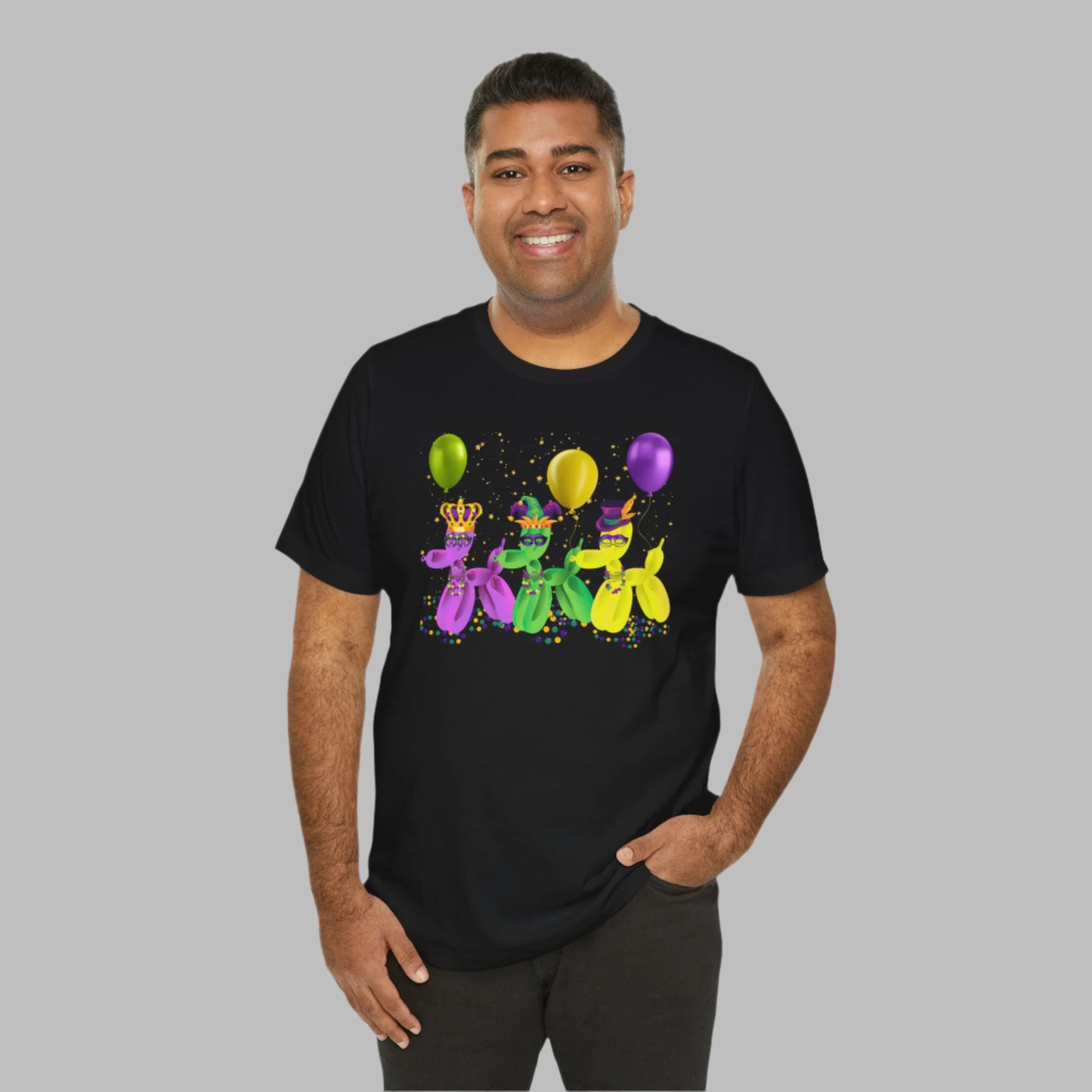 Image: Mardi Gras Balloon Dog Adult Shirt. This New Orleans Carnival tee features three balloons dogs, wearing Mardi Gras masks and hats. They have beads and balloons with confetti, by jaecrece